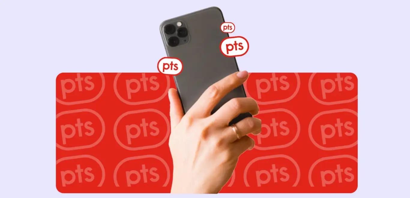 A hand holds the back camera side of a silver smartphone against a purple rectangle with faint white PC Optimum points puck pattern.